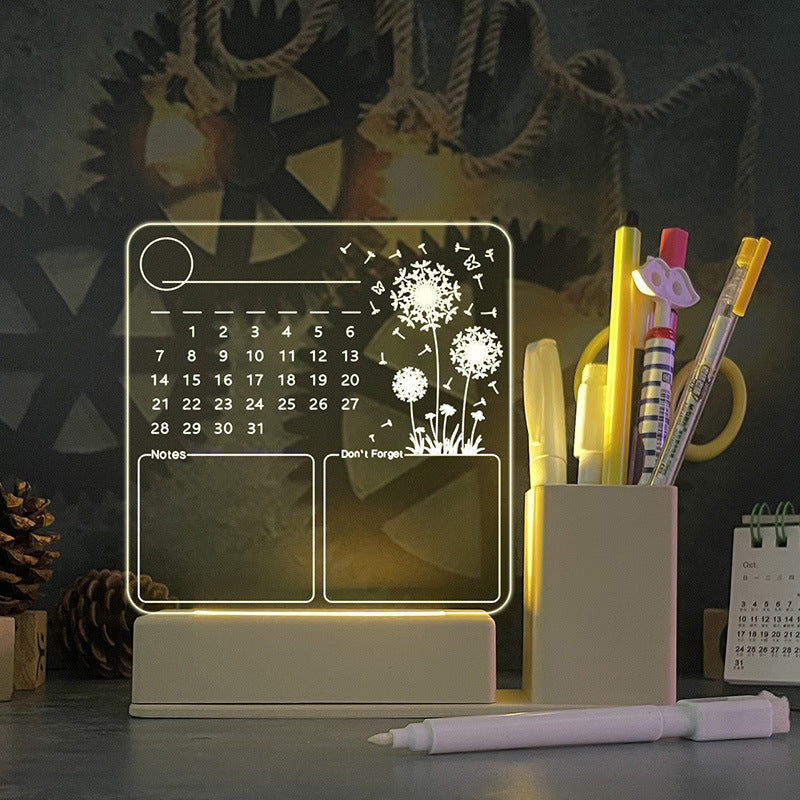 Acrylic Calendar Memo Board with glowing LED night light and dandelion design on desk with pen and USB base