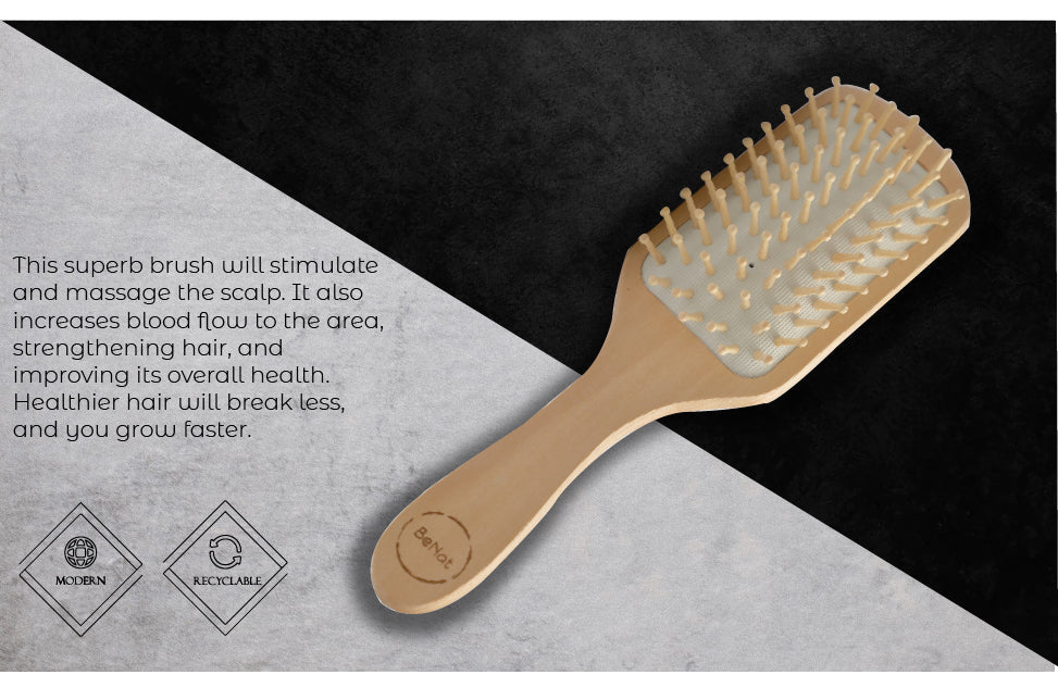 Natural wooden detangling hair brush with bamboo bristles and rubber cushioning for gentle, static-free hair care