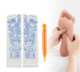 White cotton reflexology Massage Socks with blue printed acupuncture point diagrams and an orange massage stick tool shown beside a hand massaging a foot.