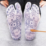 Gray cotton Massage Socks with detailed black acupressure reflexology foot diagram and labeled pressure points on sole.