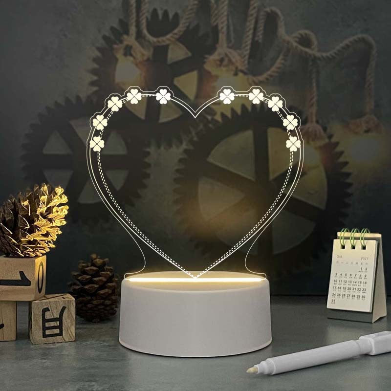 Acrylic calendar memo board with LED night light and dandelion design on desk with pen and USB base