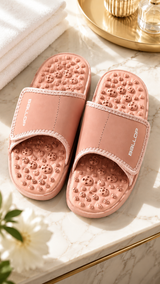 Pair of acupressure slippers with patented footbed and adjustable strap for foot tension relief and arch support