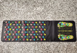 Reflexology Foot Massage Pad with black base, colorful raised pebble-like massage stones, and printed acupoint foot map.
