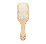 Natural wooden detangling hair brush with bamboo bristles and rubber cushioning for gentle, static-free hair care