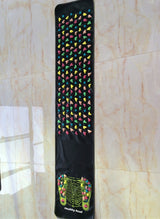 Reflexology Foot Massage Pad black mat with multicolored plastic stones and foot acupressure map for pain relief and health care.