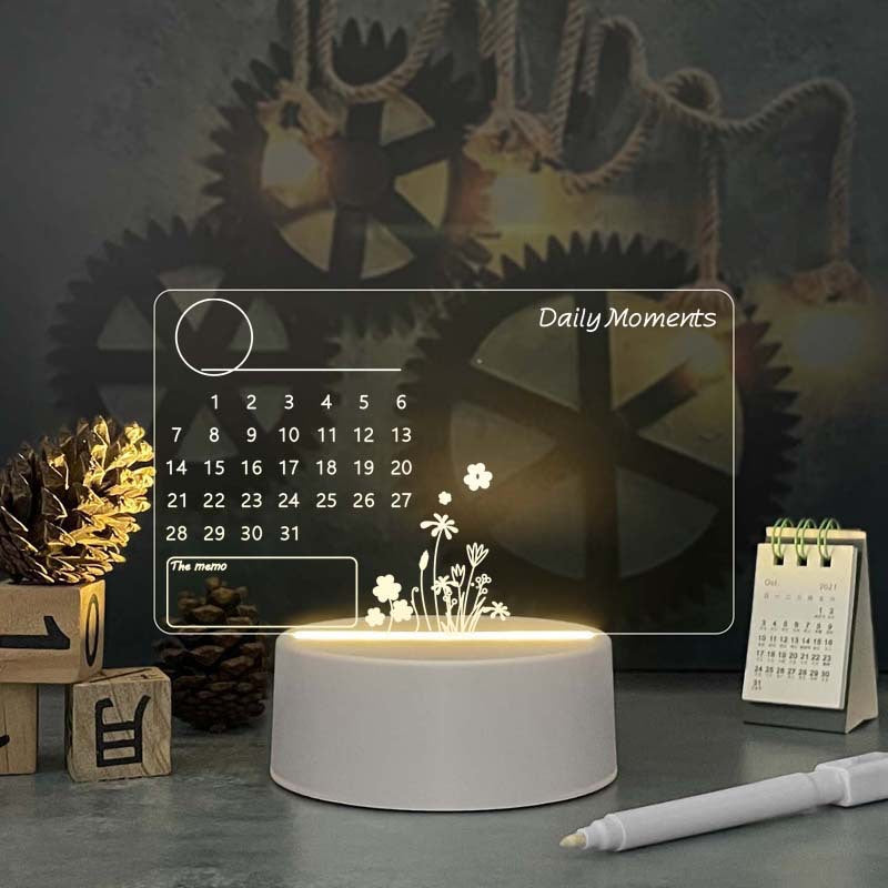Acrylic calendar memo board glowing with LED night light and pen on desk